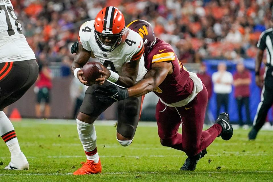 Cleveland Browns quarterback Deshaun Watson is tackled by Washington Commanders linebacker Jamin Davis during a preseason game Friday in Cleveland.