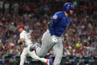Chicago Cubs' Ian Happ, right, rounds first on his way to an RBI double off St. Louis Cardinals starting pitcher Andre Pallante, left, during the fifth inning of a baseball game Friday, June 24, 2022, in St. Louis. (AP Photo/Jeff Roberson)