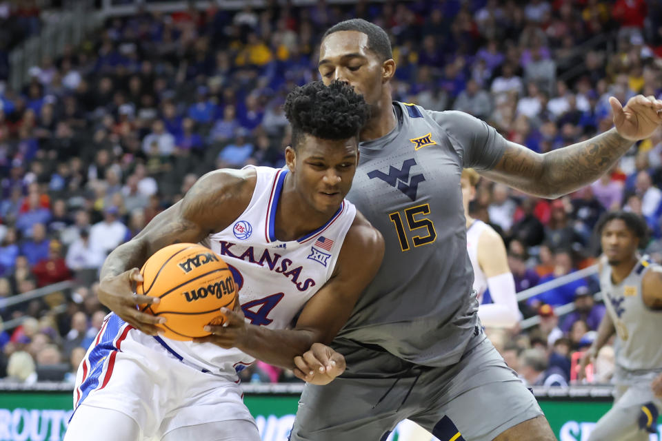 Kansas Jayhawks forward K.J. Adams Jr. (24) puts his shoulder into West Virginia Mountaineers forward Jimmy Bell Jr. (15) during a Big 12 tournament game. (Photo by Scott Winters/Icon Sportswire via Getty Images)