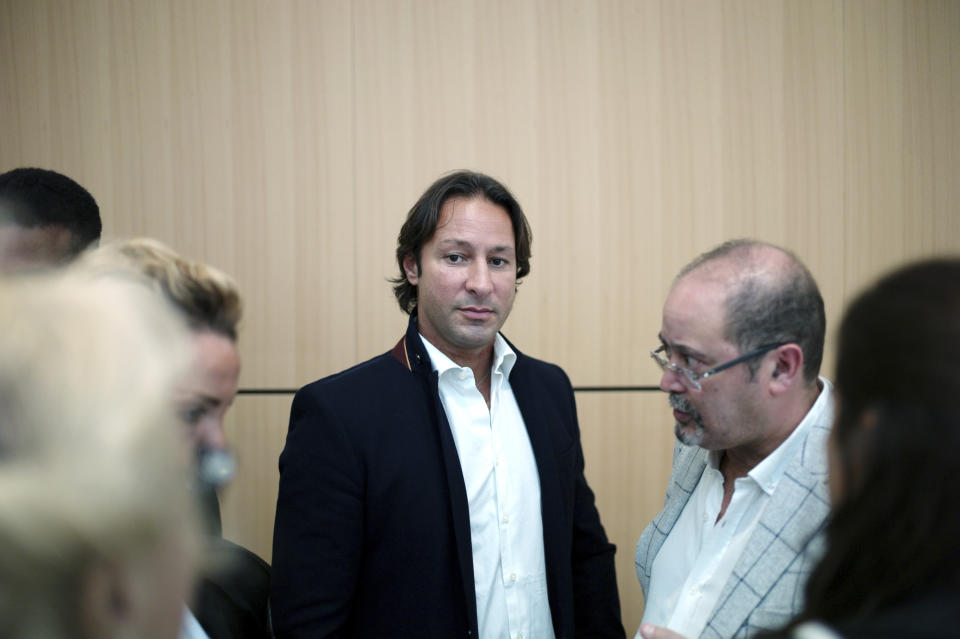 Saudi princess Hassa bint Salman's bodyguard Raina Said, center, leaves the courthouse, in Paris, Thursday, Sept. 12, 2019. The only daughter of Saudi Arabia's King Salman has been found guilty by a Paris court of charges that she ordered her bodyguard to detain and strike a plumber for taking photos at the Saudi royal family's apartment in the French capital. (AP Photo/Thibault Camus)