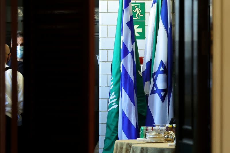 Flags of Saudi Arabia and Israel stand together in a kitchen staging area as U.S. Secretary of State Blinken holds meetings in Washington