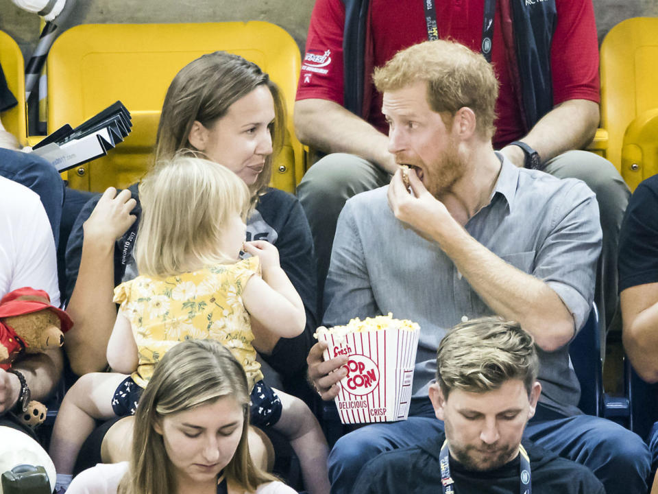 Prince Harry tucks into his popcorn