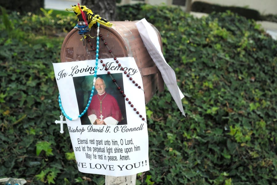 A picture with a prayer hangs on the mailbox as a makeshift memorial grows for Bishop David O’Connell, Tuesday, Feb. 21, 2023, in front of his home in Hacienda Heights, Calif., an unincorporated community about 20 miles (30 kilometers) east of downtown Los Angeles. Bishop O’Connell was shot and killed Saturday inside his home. Carlos Medina, the husband of O’Connell’s housekeeper was arrested Monday. (Keith Birmingham/The Orange County Register via AP)