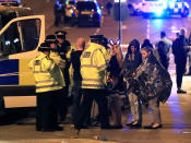 <p>Emergency services personnel speak to people outside Manchester Arena after reports of an explosion at the venue during an Ariana Grande concert in Manchester, England, Monday, May 22, 2017. Several people have died following an explosion Monday night at an Ariana Grande concert in northern England, police and witnesses said. The singer was not injured, according to a representative. (Peter Byrne/PA via AP) </p>