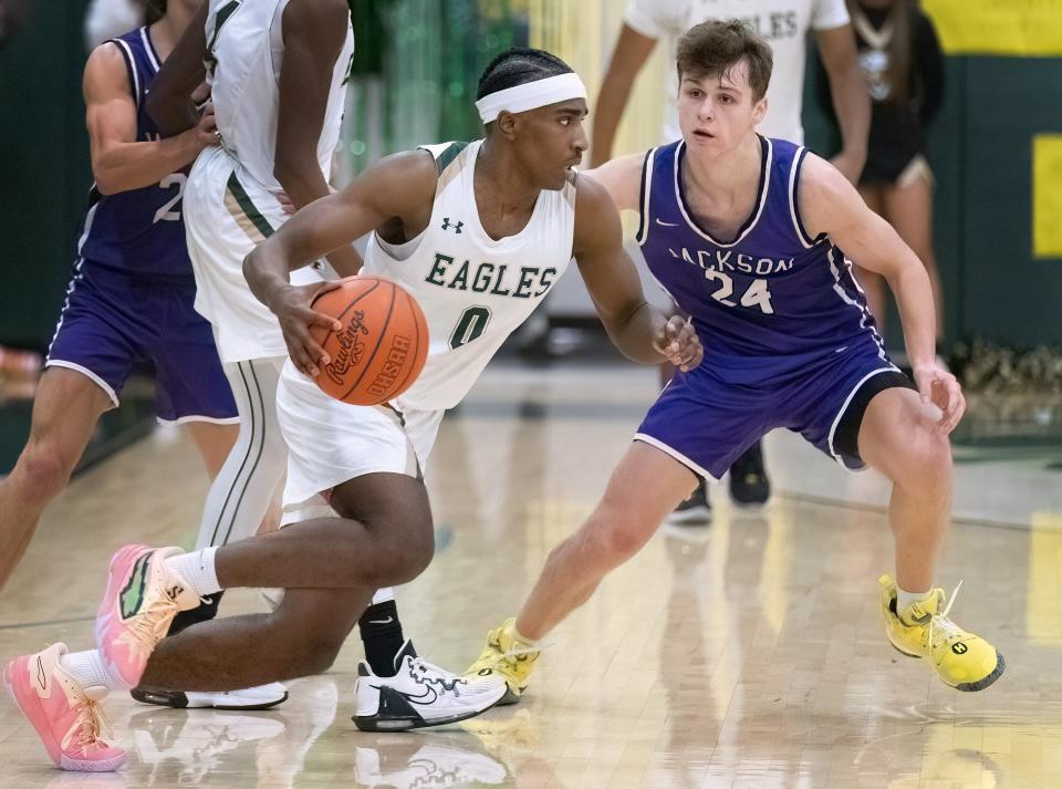 GlenOak’s Ja’Corey Lipkins drives past Jackson’s Kyle Monterrubio on Friday, Feb. 2, 2024.