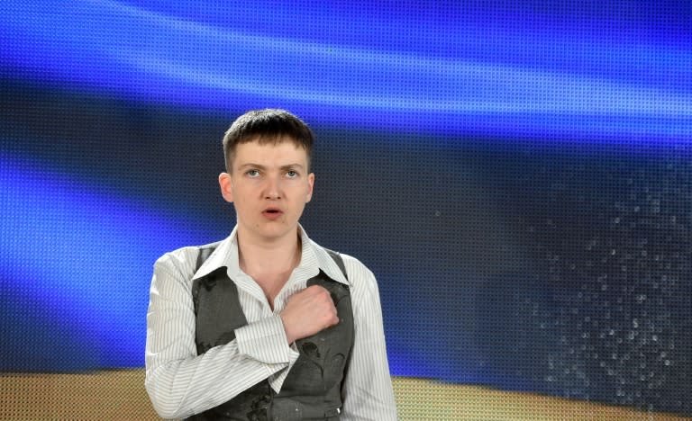 Ukrainian pilot Nadiya Savchenko sings the national anthem during a press conference in Kiev on May 27, 2016