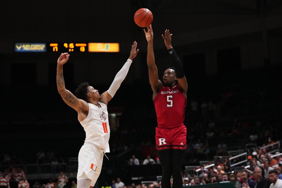 Rutgers Scarlet Knights forward Aundre Hyatt (5) shoots the ball over Miami Hurricanes guard Jordan Miller (11) during the first half at Watsco Center.