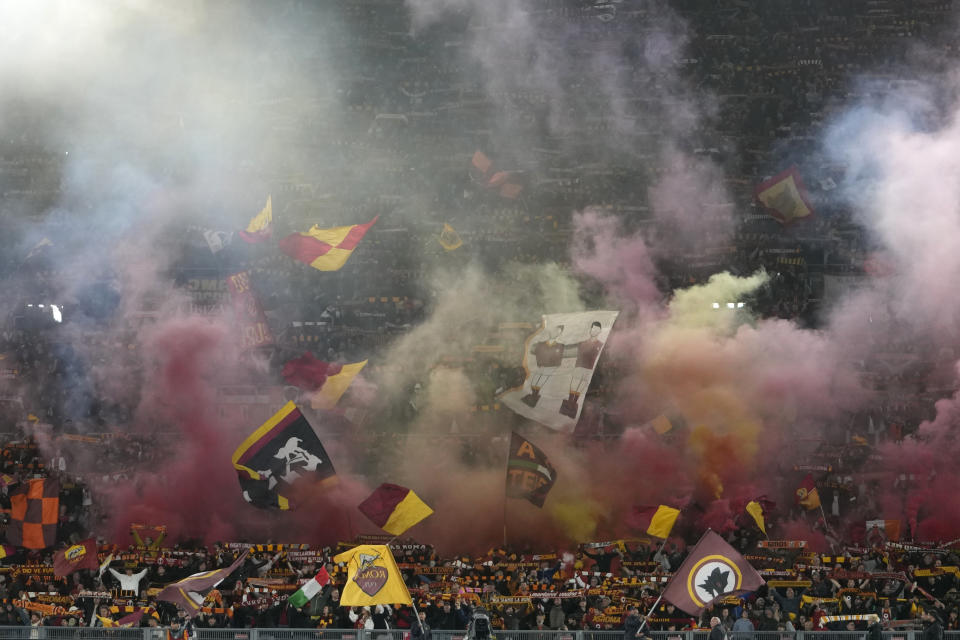 Fans light flares during the Europa League semifinal first leg soccer match between Roma and Bayer Leverkusen at Rome's Olympic Stadium, Italy, Thursday, May 2, 2024. (AP Photo/Alessandra Tarantino)
