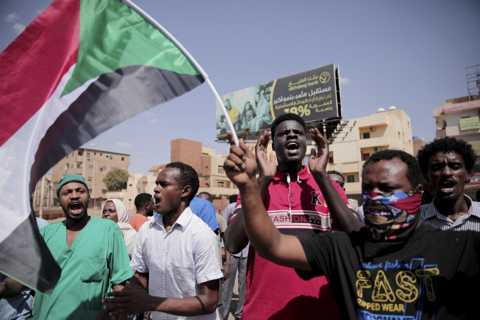 People chant slogans during a protest in Khartoum, Sudan, Saturday, Oct. 30, 2021. Pro-democracy groups called for mass protest marches across the country Saturday to press demands for re-instating a deposed transitional government and releasing senior political figures from detention. (AP Photo/Marwan Ali)