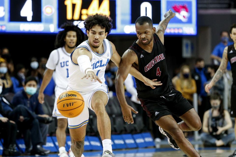 UCLA guard Jules Bernard and Chico State guard Joshua Hamilton chase the ball.