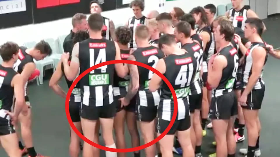 Collingwood's Jordan De Goey can be seen here touching teammate Isaac Quaynor on the bum.