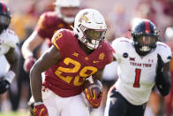 Iowa State running back Breece Hall (28) runs from Texas Tech linebacker Krishon Merriweather (1) during the first half of an NCAA college football game, Saturday, Oct. 10, 2020, in Ames, Iowa. (AP Photo/Charlie Neibergall)