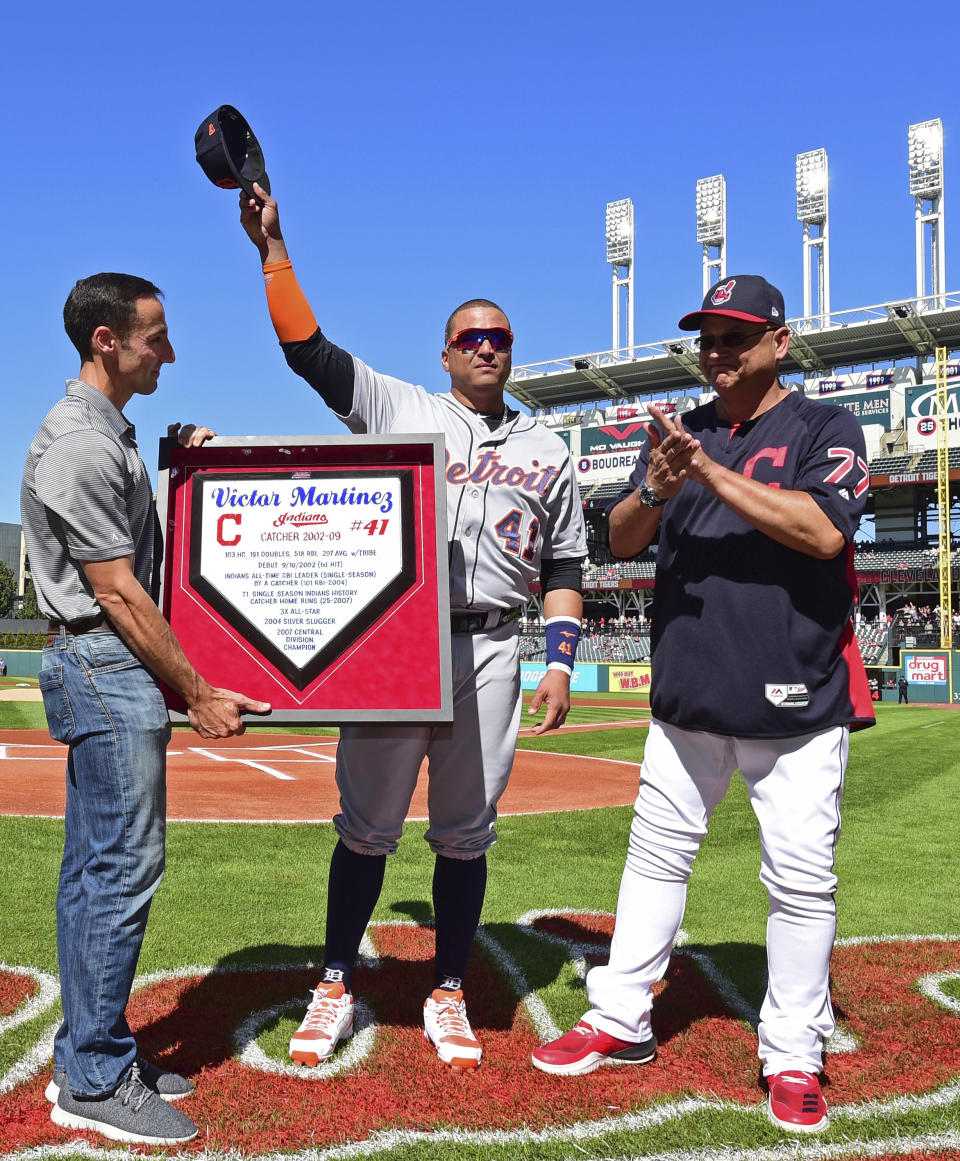 Detroit Tigers' Victor Martinez, center, waves to fans acknowledging his retirement during a pregame ceremony before a baseball game between the Cleveland Indians and Detroit Tigers, Saturday, Sept.15, 2018, in Cleveland. (AP Photo/David Dermer)