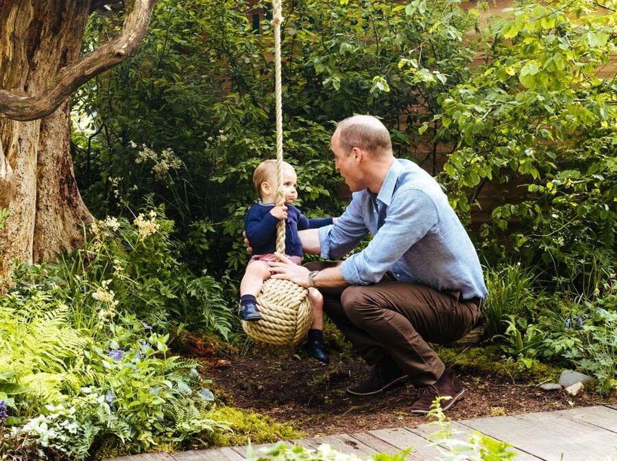 Prince William and Prince Louis play with a rope swing in the Adam White and Andree Davies co-designed "Back to Nature" garden ahead of the RHS Chelsea Flower Show on May 19, 2019 in London, England.