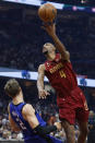 Cleveland Cavaliers forward Evan Mobley (4) shoots against Orlando Magic center Moritz Wagner (21) during the first half of an NBA basketball game Friday, Dec. 2, 2022, in Cleveland. (AP Photo/Ron Schwane)