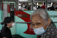 People ride a bus during the first day of a more relaxed lockdown that was placed to prevent the spread of the new coronavirus in Manila, Philippines on Monday, June 1, 2020. Traffic jams and crowds of commuters are back in the Philippine capital, which shifted to a more relaxed quarantine with limited public transport in a high-stakes gamble to slowly reopen the economy while fighting the coronavirus outbreak. (AP Photo/Aaron Favila)