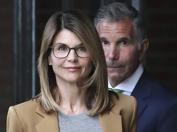 Lori Loughlin, front, and husband, clothing designer Mossimo Giannulli