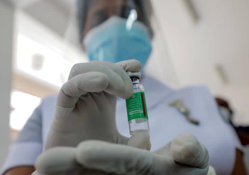 FILE PHOTO: A Health official shows a bottle with a dose of the AstraZeneca's COVID-19 vaccine manufactured by the Serum Institute of India, at Infectious Diseases Hospital in Colombo