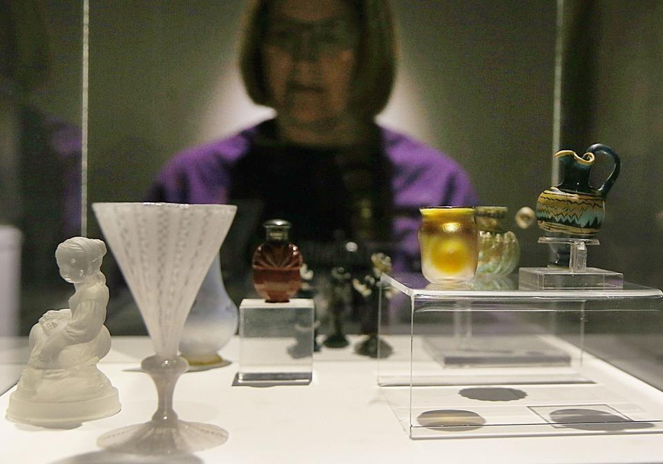 Ames resident Rhonda Evans looks at tiny sculptures, paintings, and decorative arts from the "Small Pleasures" permanent collection at Iowa State University's Brunnier Art Museum Thursday, Feb. 22, 2024 at the Scheman Building.