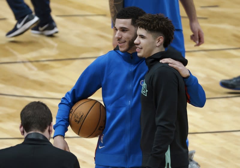 Lonzo, left, and LaMelo Ball pose for a photo before their first NBA game playing each other other on Jan. 7, 2020.