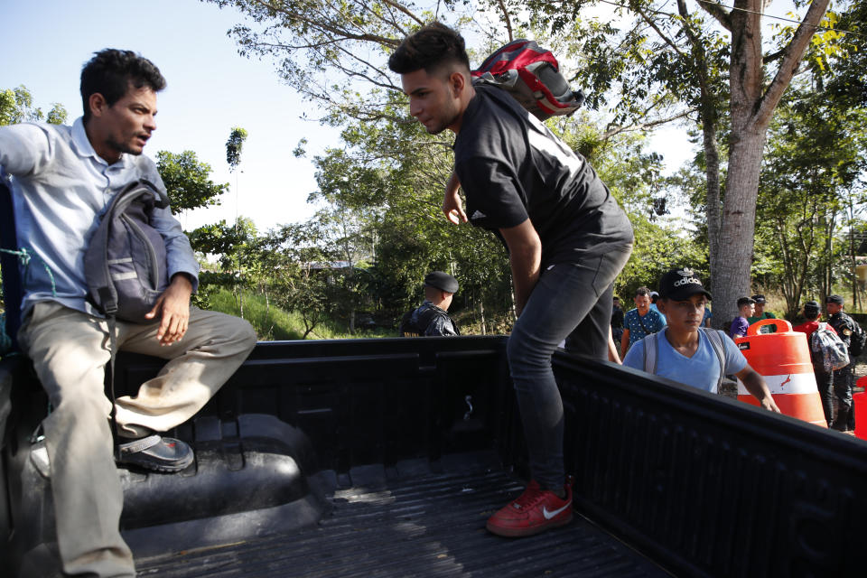 Honduras migrants trying to reach the United States get in the bed of a police pickup truck before return to Honduran border, in Morales, Guatemala, Wednesday, Jan. 15, 2020. Hundreds of mainly Honduran migrants started walking and hitching rides Wednesday from the city of San Pedro Sula and crossed the Guatemala border in a bid to form the kind of migrant caravan that reached the U.S. border in 2018. (AP Photo/Moises Castillo)
