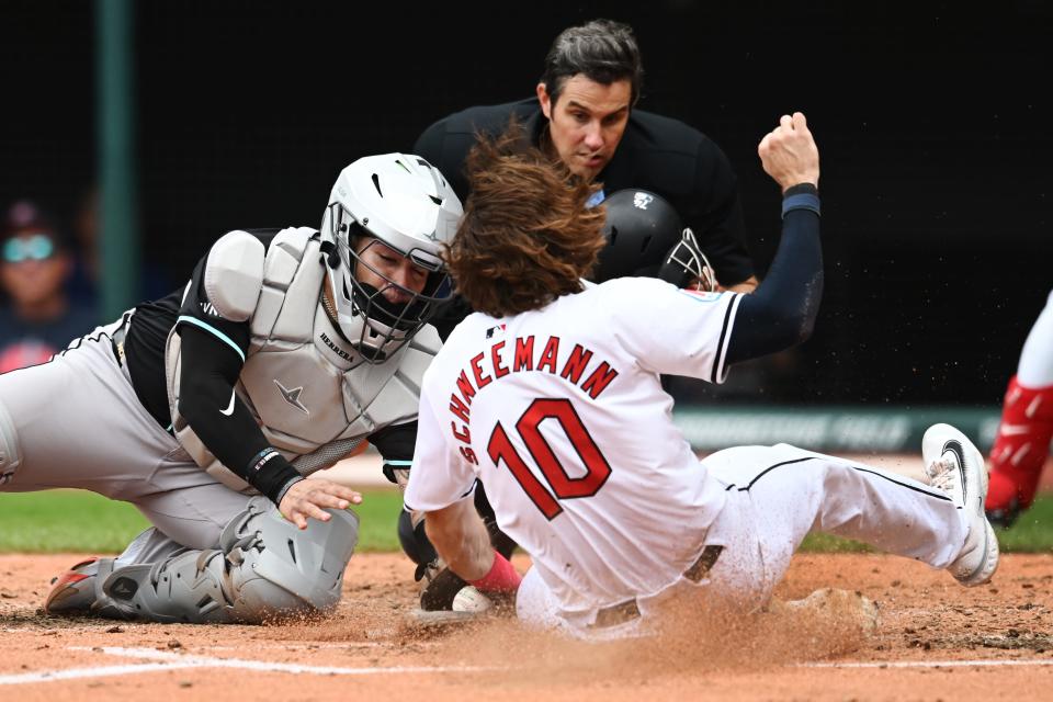 Aug 7, 2024; Cleveland, Ohio, USA; Arizona Diamondbacks catcher Jose Herrera (11) tags out Cleveland Guardians third baseman Daniel Schneemann (10) during the fifth inning at Progressive Field. Mandatory Credit: Ken Blaze-USA TODAY Sports