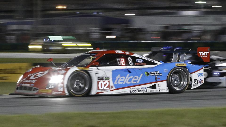 Tony Kanaan drives the Ganassi Riley DP through a turn during the IMSA Series Rolex 24 hour auto race at Daytona International Speedway in Daytona Beach, Fla., Saturday, Jan. 25, 2014.(AP Photo/John Raoux)