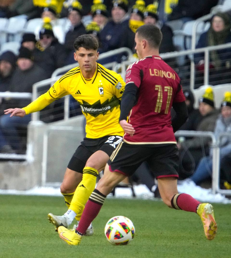 Feb 24, 2024; Columbus, OH, USA; Columbus Crew forward Max Arfsten (27) looks to block Atlanta United defender Brooks Lennon (11) at Lower.com Field.