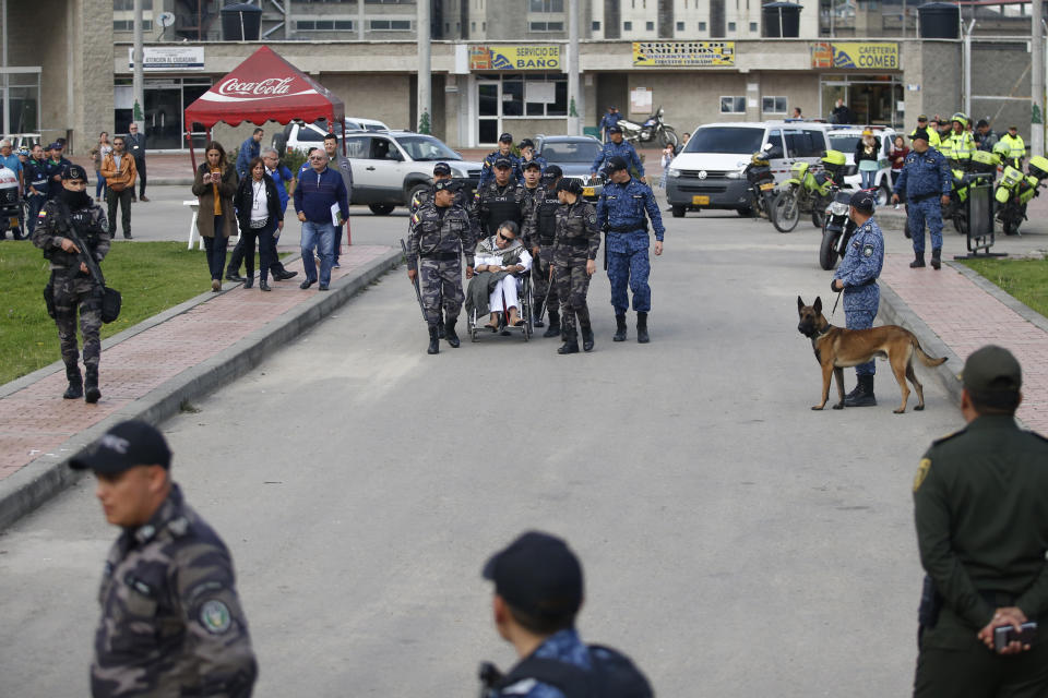 Former rebel leader Seuxis Hernandez leaves La Picota jail escorted by prison guards in Bogota, Colombia, Friday, May 17, 2019. The former peace negotiator, best known by his alias Jesús Santrich, was re-arrested immediately after his release that was orderer by a special tribunal investigating war crimes during Colombia's civil conflict that ruled Wednesday that he should not be extradited to the United States. (AP Photo/Fernando Vergara)