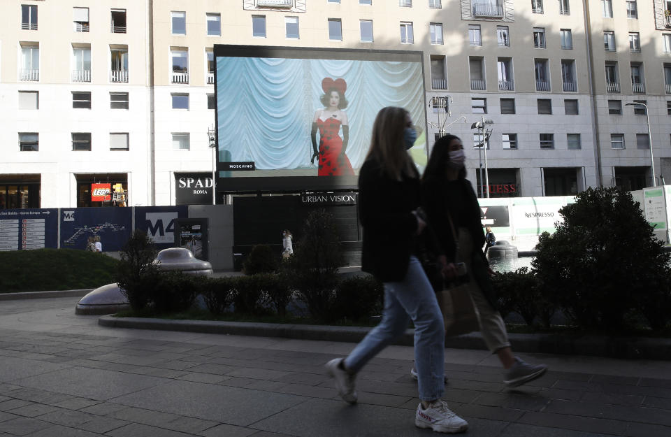 A giant screen streams a Moschino fashion live show presenting the women's Fall Winter 2021-22 collection, unveiled during the Fashion Week in Milan, Italy, Thursday, Feb. 25, 2021. (AP Photo/Antonio Calanni)