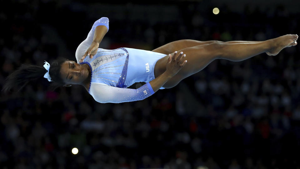 FILE- In this Oct. 5, 2019, file photo, Simone Biles, of the United States, performs on the floor during qualifying sessions for the Gymnastics World Championships in Stuttgart, Germany. (AP Photo/Matthias Schrader)