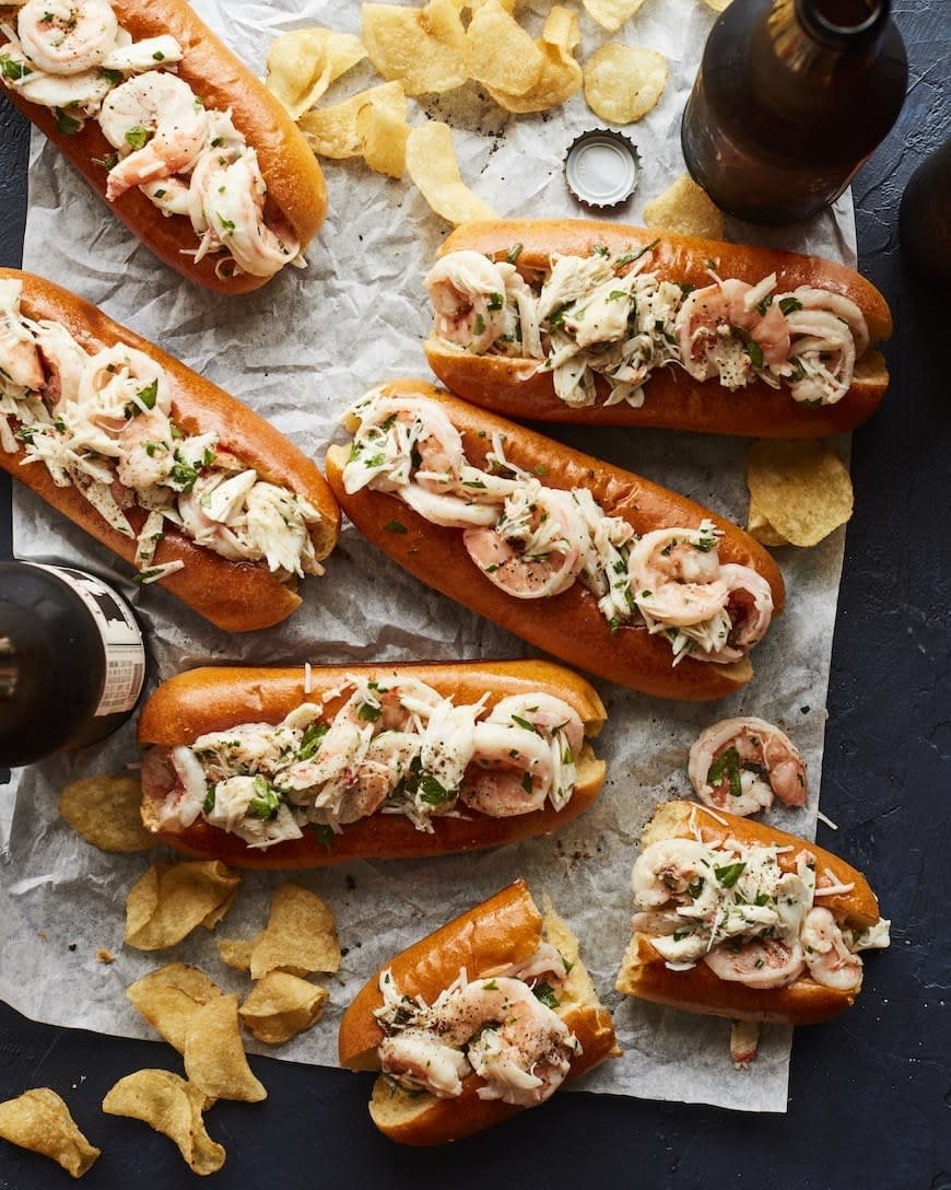 Crab and shrimp rolls with potato chips.