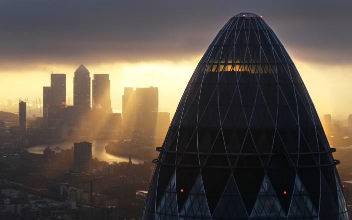     The sun rises over the City of London