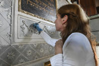 Rita Ranzato, an art restorer, uses a scalpel to take away layers of old paint from a stuccoed wall inside the 1575 Italian Schola Synagogue in Venice, northern Italy, Wednesday, June 1, 2022. Venice’s Jewish ghetto is considered the first in Europe and one of the first in the world, and a new effort is underway to preserve its 16th century synagogues for the Jews who have remained and tourists who pass through. (AP Photo/Chris Warde-Jones)