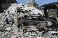 A Lebanese man checks a destroyed house that was hit by an Israeli airstrike, in Alma al-Shaab, a Lebanese border village with Israel, south Lebanon, Wednesday, April 17, 2024. Hezbollah militants and Israeli forces have been exchanging fire since a day after the Israel-Hamas war began on Oct. 7. (AP Photo/Mohammed Zaatari)