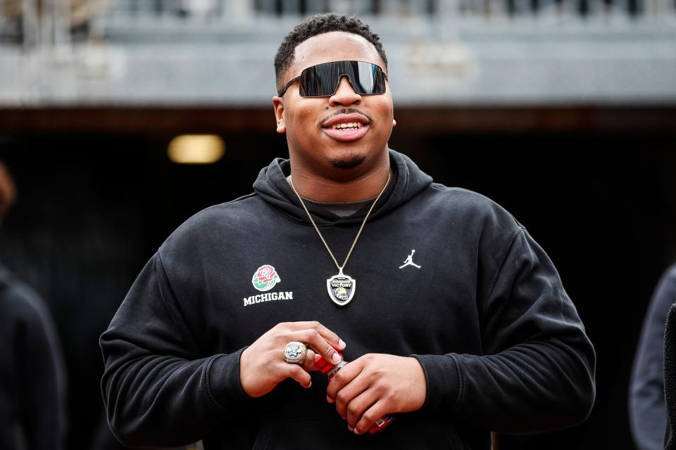 Former Michigan player Kris Jenkins walks toward the field during the spring game at Michigan Stadium in Ann Arbor on Saturday, April 20, 2024.