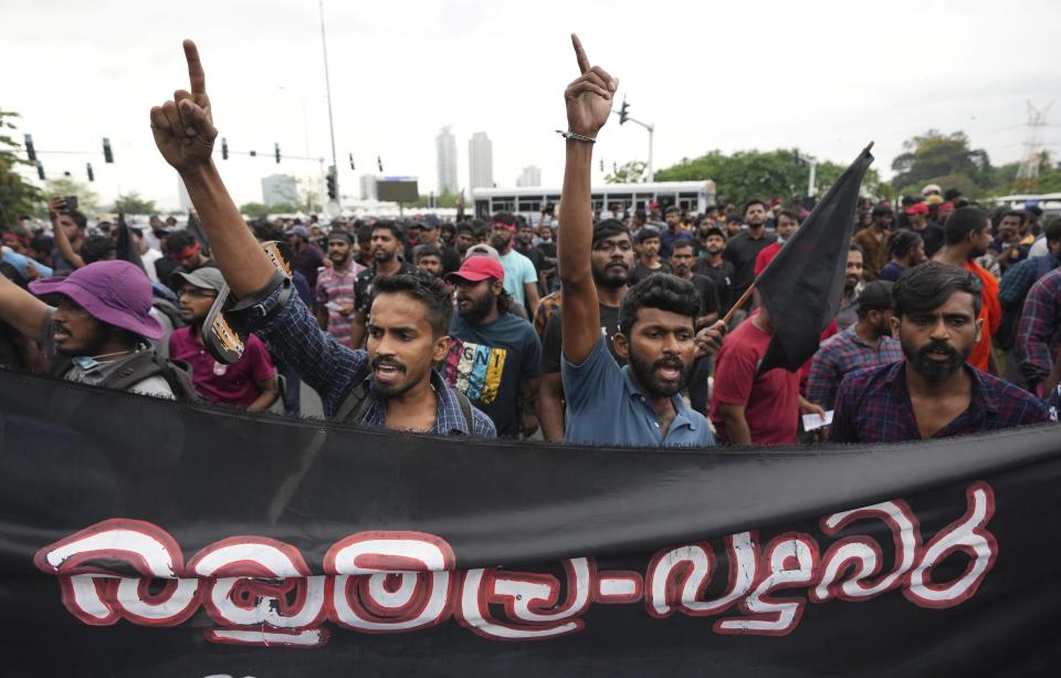 FILE - Sri Lankan undergraduates shout slogans demanding president Gotabaya Rajapaksa's resignation during a protest near parliament in Colombo, Sri Lanka, April 8, 2022. With one brother president, another prime minister and three more family members cabinet ministers, it appeared that the Rajapaksa clan had consolidated its grip on power in Sri Lanka after decades in and out of government. With a national debt crisis spiraling out of control, it looks like the dynasty is nearing its end with Prime Minister Mahinda stepping down on Monday, May 9, 2022, and the three Rajapaksas resigning their cabinet posts in April, but the family is not going down without a fight. (AP Photo/Eranga Jayawardena, File)