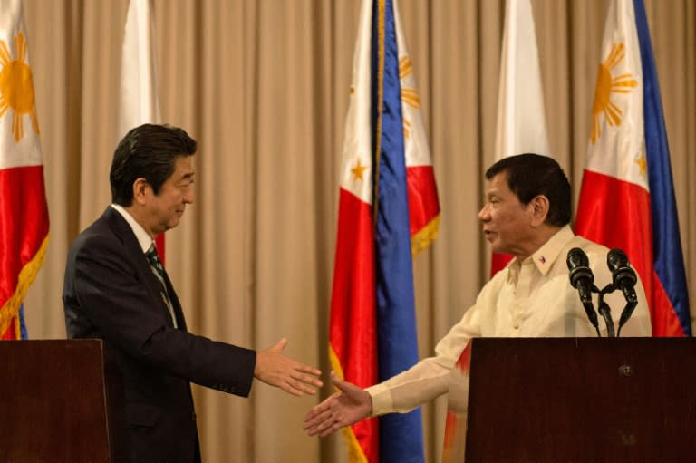 Philippine President Rodrigo Duterte (R) and Japanese Prime Minister Shinzo Abe (L) are expected to discuss territorial disputes with China