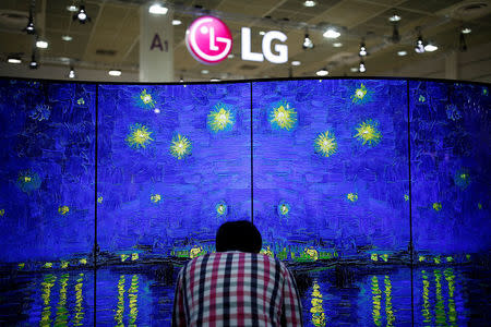 A man examins LG Electronics' double-faced and curved OLED TV during Korea Electronics Show 2016 in Seoul, South Korea, October 27, 2016. REUTERS/Kim Hong-Ji