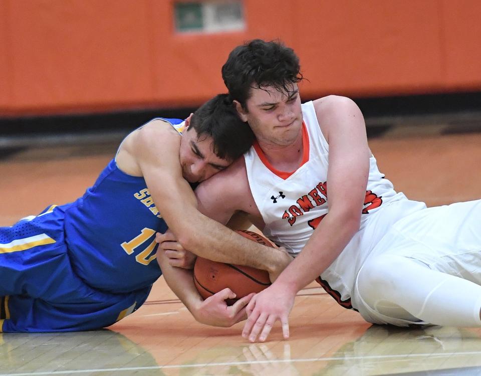 Shanksville-Stonycreek's Christian Musser, left, and Somerset's Aiden VanLenten wrestle for possession of the ball during the nightcap of the Pine Grill Roundball Classic, Dec. 2, in Somerset.
