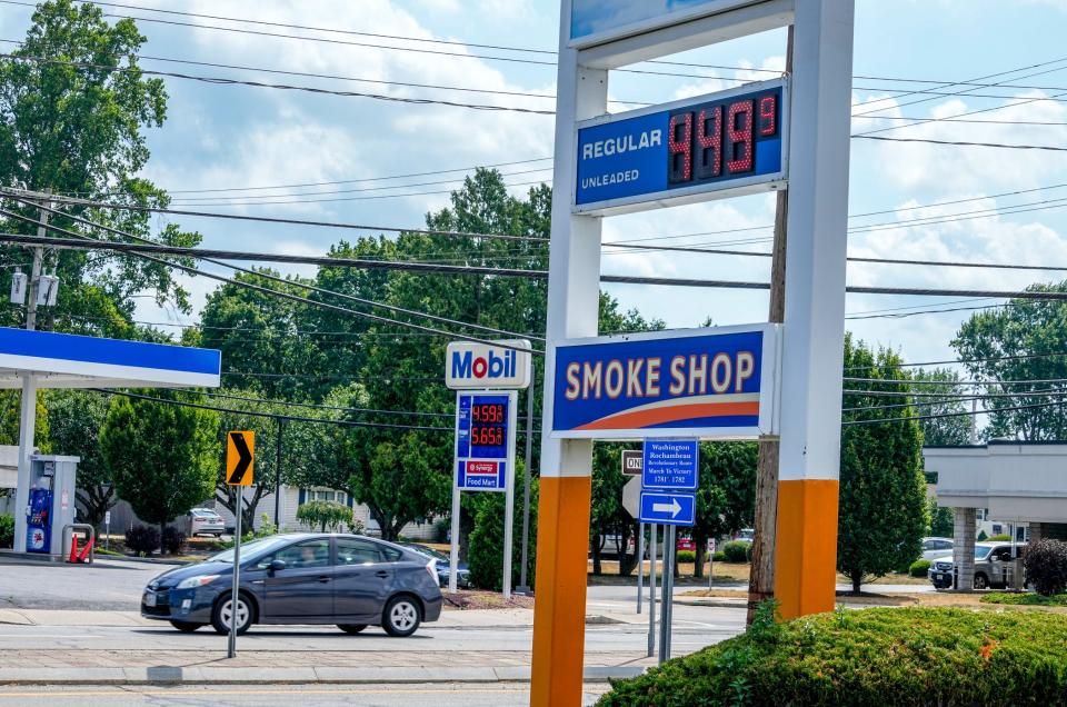 Signs at competing gas stations in East Providence show prices softened from a June peak but still not far from $5 a gallon.