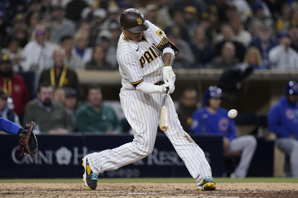 San Diego Padres' Manny Machado hits an RBI-double during the sixth inning of a baseball game against the Chicago Cubs, Tuesday, May 10, 2022, in San Diego. (AP Photo/Gregory Bull)