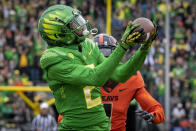 Oregon wide receiver Devon Williams (2) hauls in a touchdown pass over Oregon State defensive back Rejzohn Wright (1) during the first quarter of an NCAA college football game Saturday, Nov. 27, 2021, in Eugene, Ore. (AP Photo/Andy Nelson)