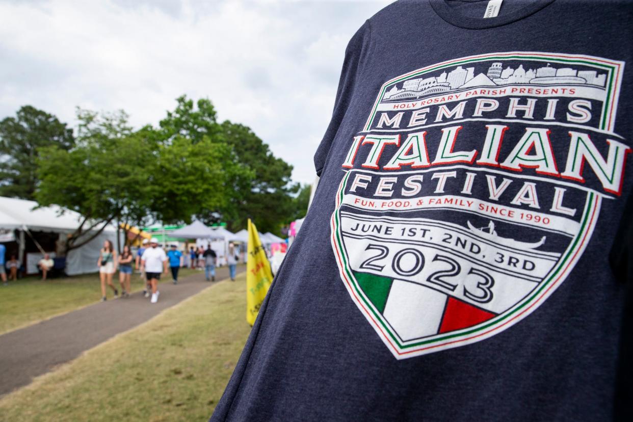 A festival shirt blows in the wind as attendees walk by during the Memphis Italian Festival at Marquette Park in Memphis, Tenn., on Friday, June 2, 2023. 