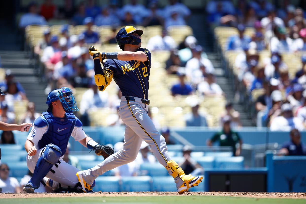 LOS ANGELES, CALIFORNIA - JULY 07: Christian Yelich #22 of the Milwaukee Brewers hits a two-run home run against the Los Angeles Dodgers in the fourth inning at Dodger Stadium on July 07, 2024 in Los Angeles, California. (Photo by Ronald Martinez/Getty Images)