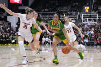 Oregon guard Sofia Bell (3) drives past Stanford forward Brooke Demetre (21) during the first half of an NCAA college basketball game Friday, Jan. 19, 2024, in Stanford, Calif. (AP Photo/Tony Avelar)