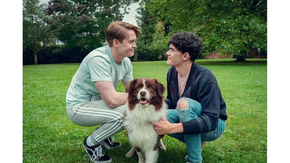 Nick and Charlie staring at each other in a park