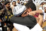 A freed Houthi prisoner hugs a relative after his release in a prisoner swap, in Sanaa airport