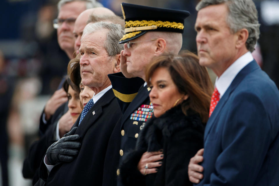 Former U.S. President George W. Bush and members of the Bush family watch as a joint services military honor guard carries the flag-draped casket of former U.S. President George H.W. Bush from the U.S. Capitol