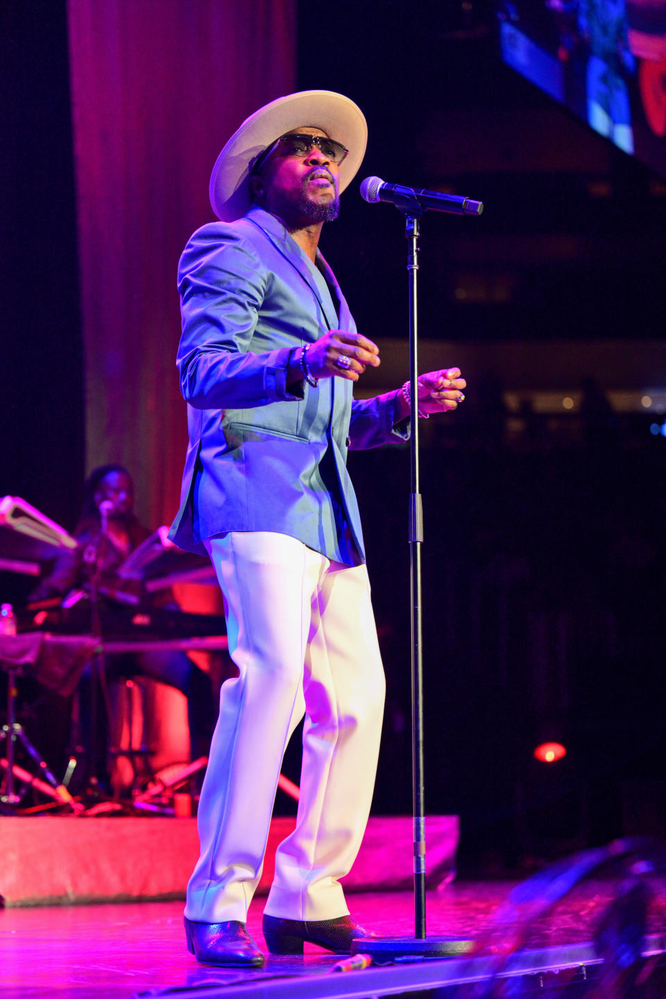 Anthony Williams sings onstage in front of a mic stand